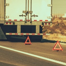 a truck with warning signs on the road